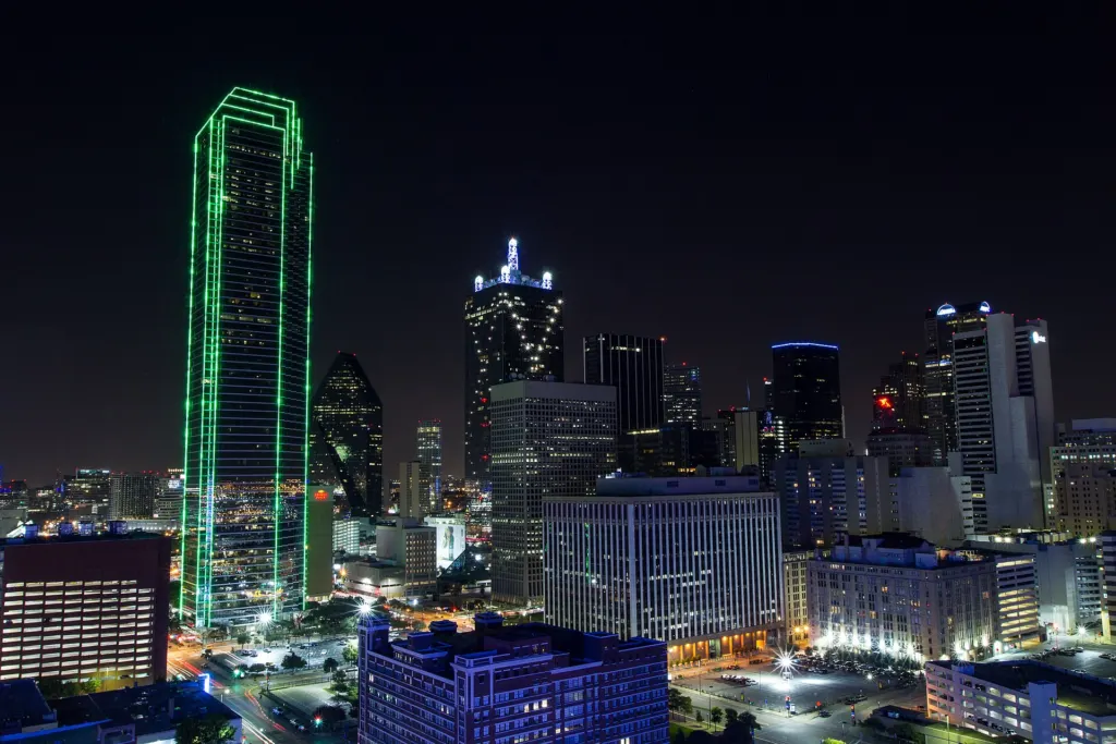The downtown Dallas skyline lit up at night, seen from the south