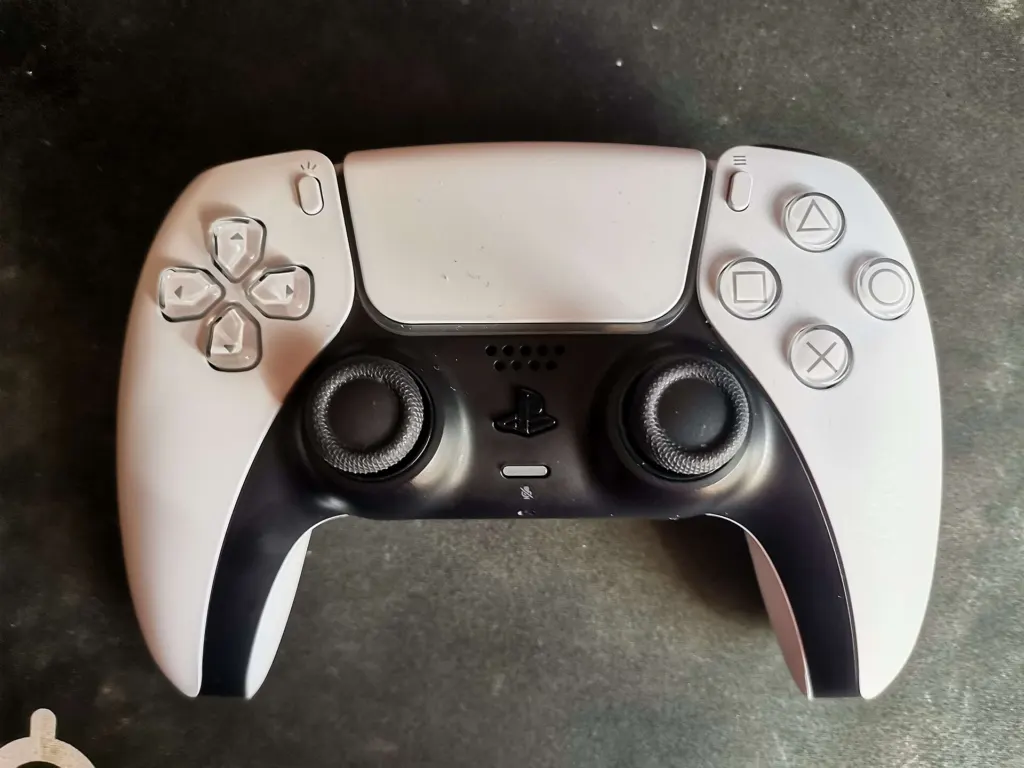 A white PlayStation 5 DualSense wireless controller photographed close up