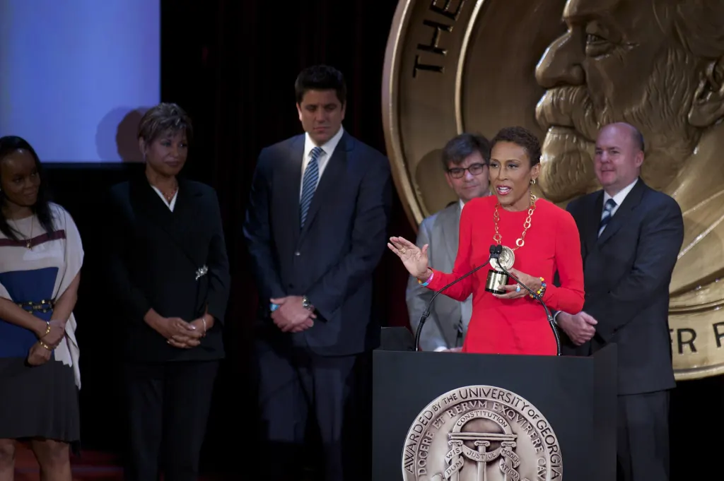George Stephanopoulos and Robin Roberts standing with colleagues at the 72nd Peabody Awards luncheon in New York, May 2013