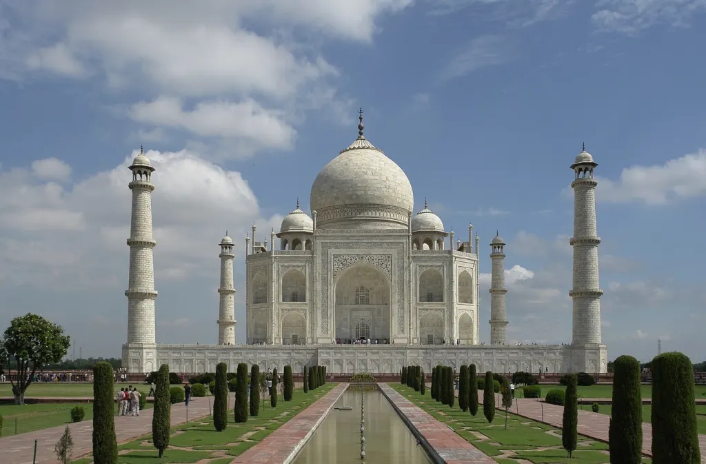 The south face of the white marble Taj Mahal in Agra, India, with its central dome and four minarets under a clear sky