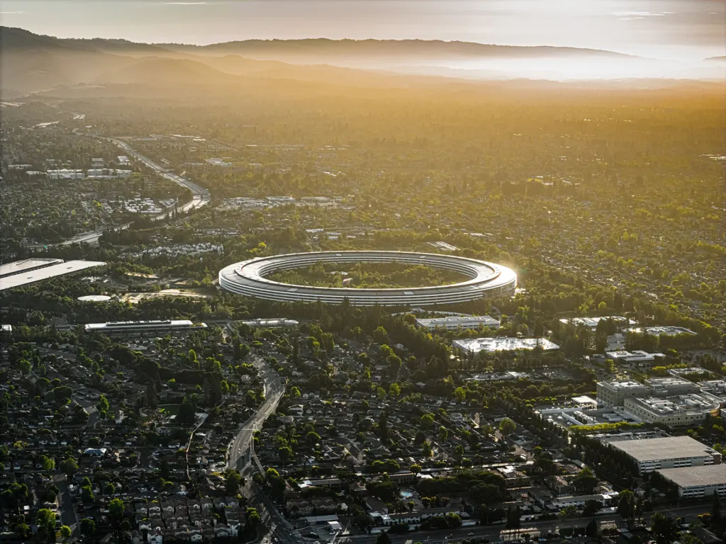 Aerial view of Apple's ring-shaped Apple Park headquarters in Cupertino, California, at sunset