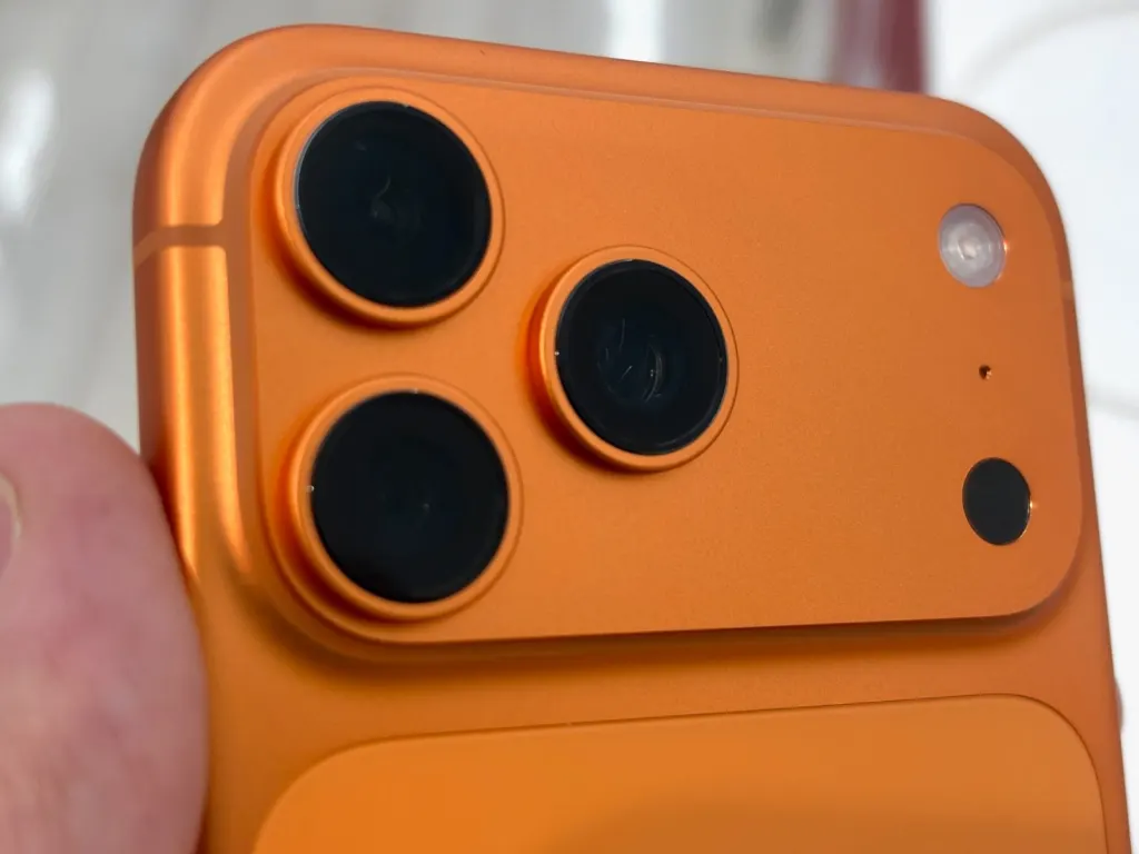 An iPhone 17 Pro Max in Cosmic Orange