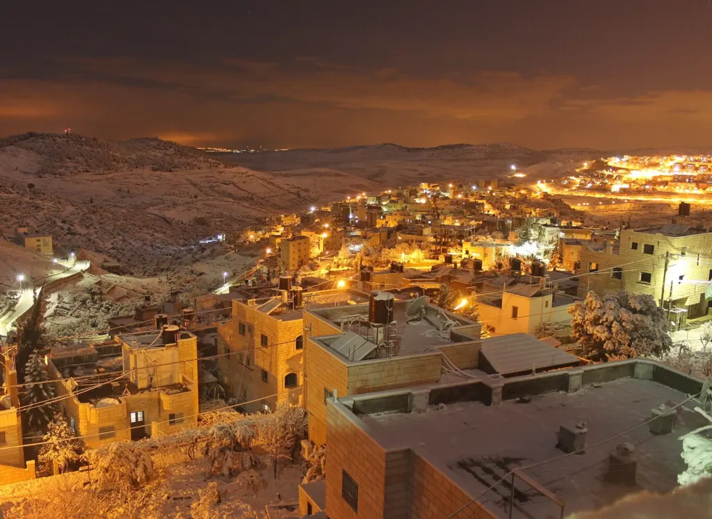 The village of Nahalin, southwest of Bethlehem in the West Bank, covered in snow on its hillside terraces