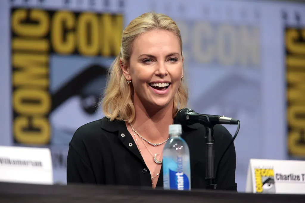 Charlize Theron speaking on a panel stage at San Diego Comic-Con in July 2017