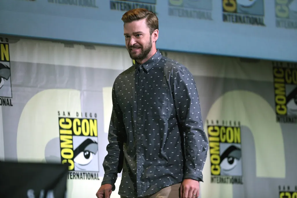 Justin Timberlake speaking into a microphone on a panel stage at San Diego Comic-Con in 2016