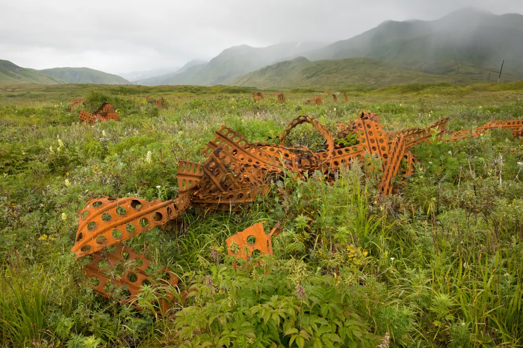 Twisted strips of perforated steel Marston matting lying in the tundra on Attu Island in Alaska's Aleutians