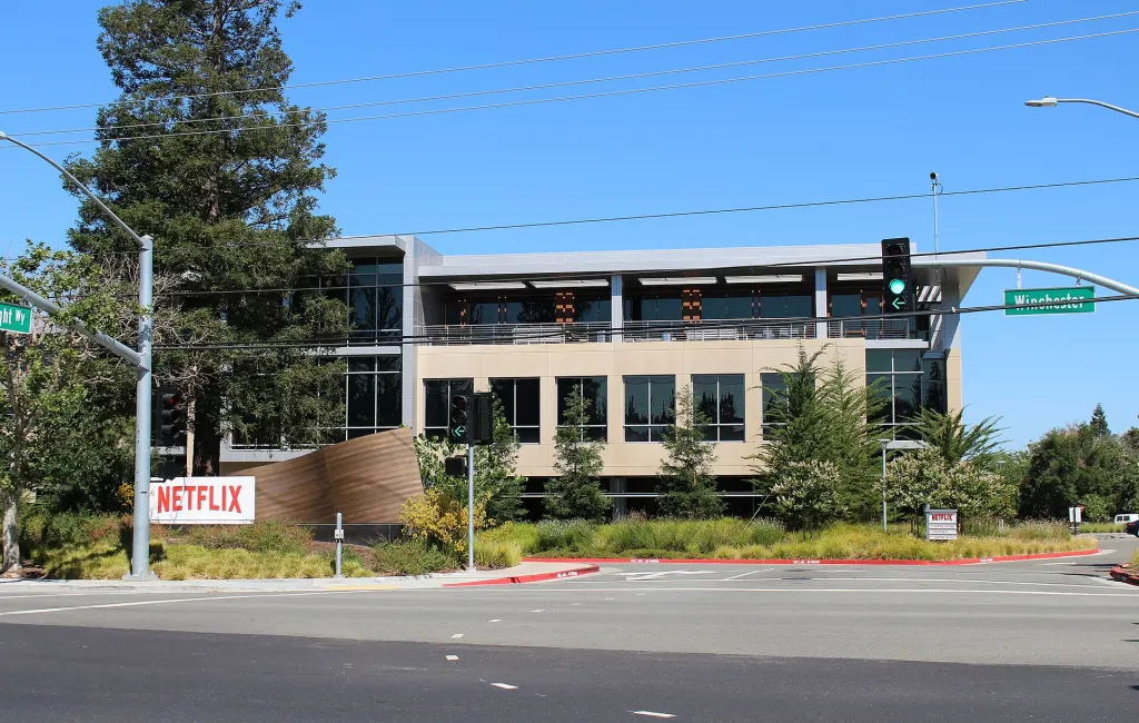 A modern glass-fronted office building at 101 Albright Way on Netflix's headquarters campus in Los Gatos, California
