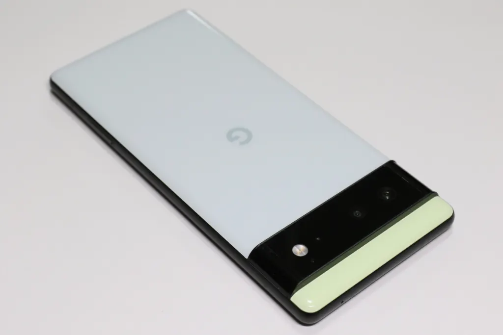 The back of a Google Pixel 6 in Sorta Seafoam green, showing its horizontal black camera bar