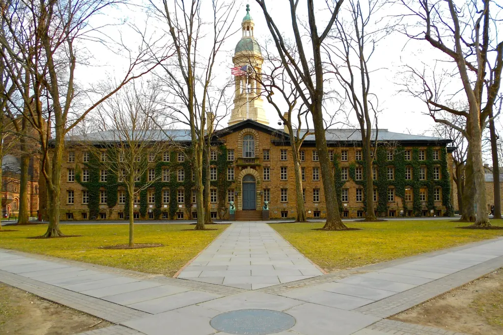 Nassau Hall, the historic stone main building of Princeton University, seen across a lawn