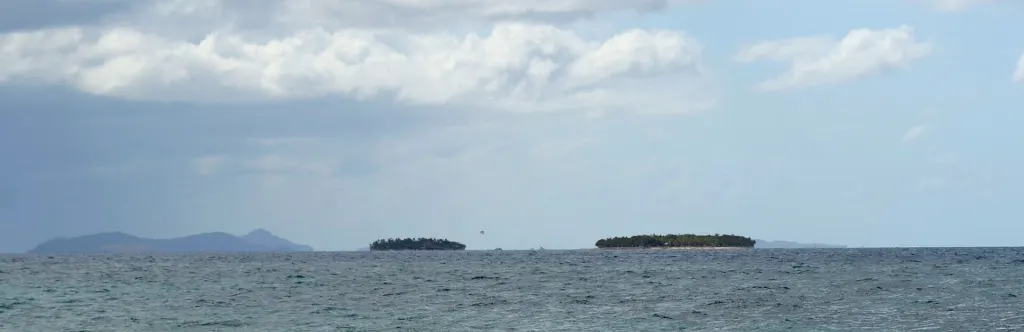Panorama of the Mamanuca Islands in Fiji, showing Mana, Beachcomber, Treasure and Tokoriki islands across the water
