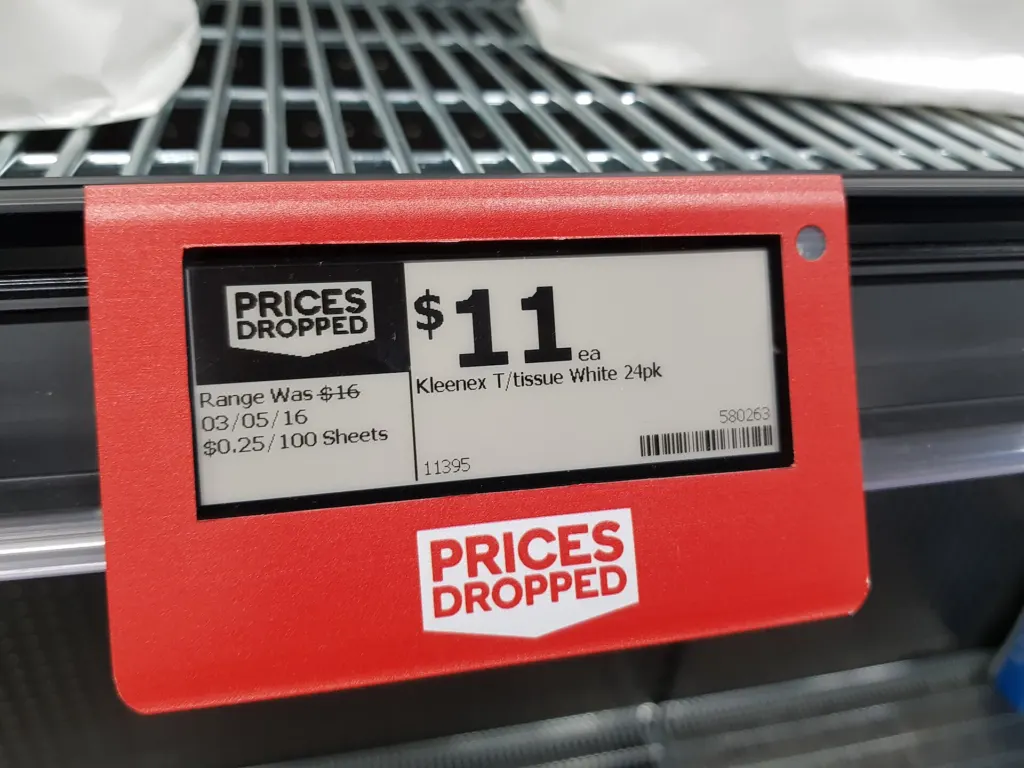 An electronic e-ink price label mounted on a supermarket shelf edge below packaged products